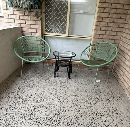 Textured concrete flooring in an outdoor seating area