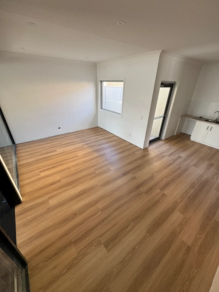 Spacious room with natural timber flooring featuring a warm matte finish and detailed wood grain pattern.