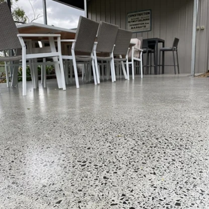 Polished epoxy flooring in a modern commercial space with a smooth speckled finish